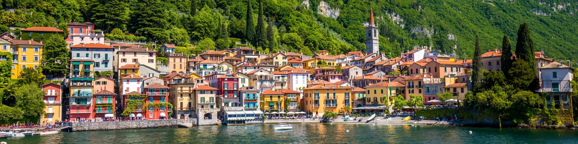 VARENNA, ITALY - June 1, 2019 - Varenna old town with the mountains in the background, Italy, Europe.