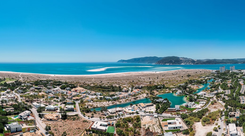 Aerial drone panoramic view of Troia, a peninsula located in Grandola Municipality, next to Sado River estuary, with Arrabida mountain range on left, Alentejo, Portugal