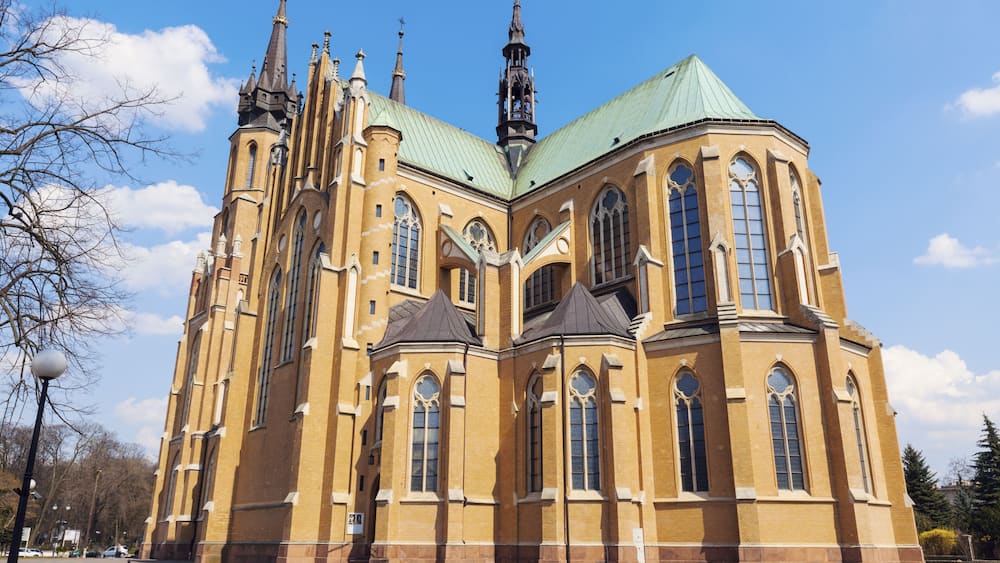 A large, historic church with a green roof and multiple spires.
