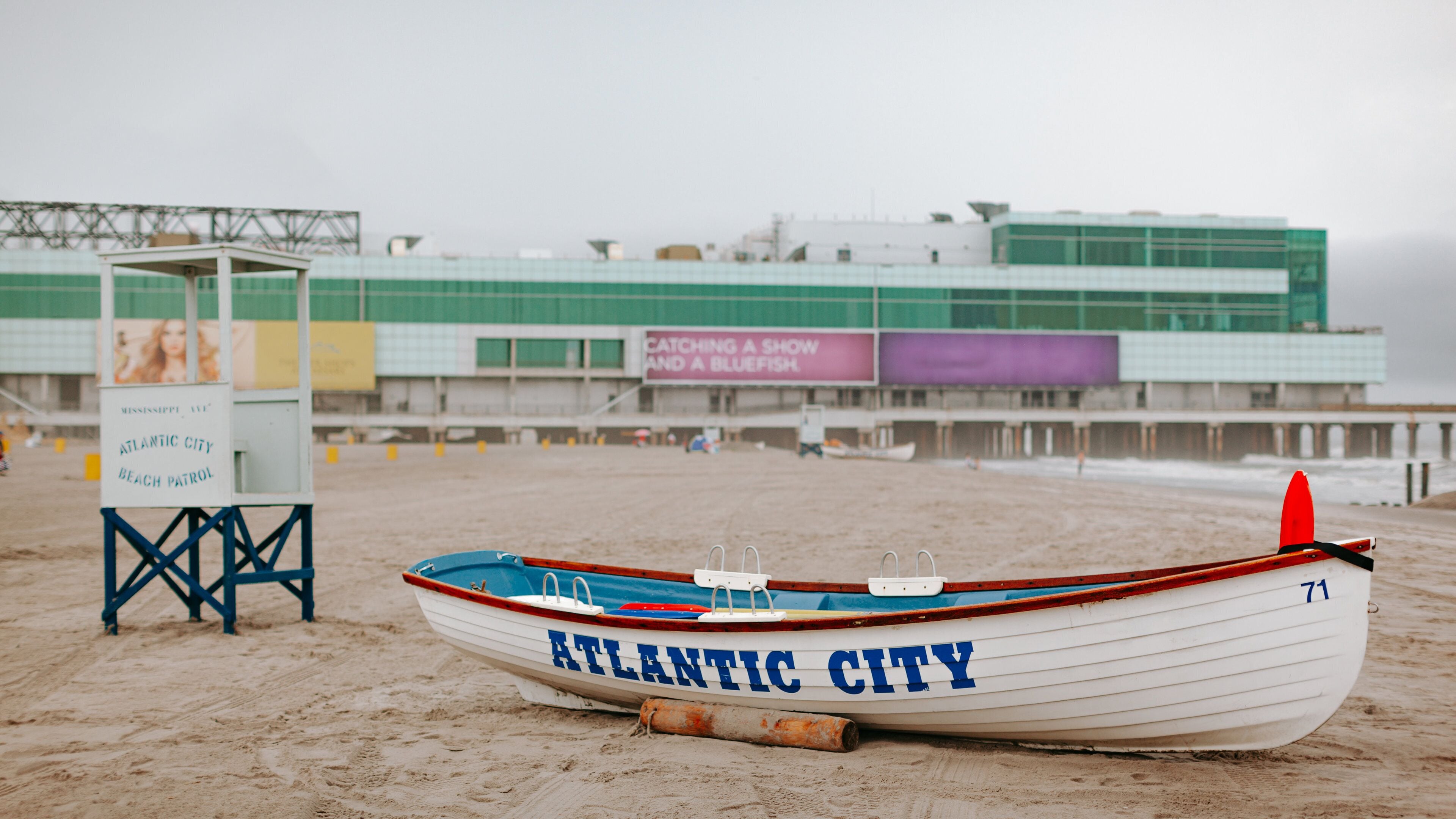 Atlantic City Boardwalk featuring a beach and signage
