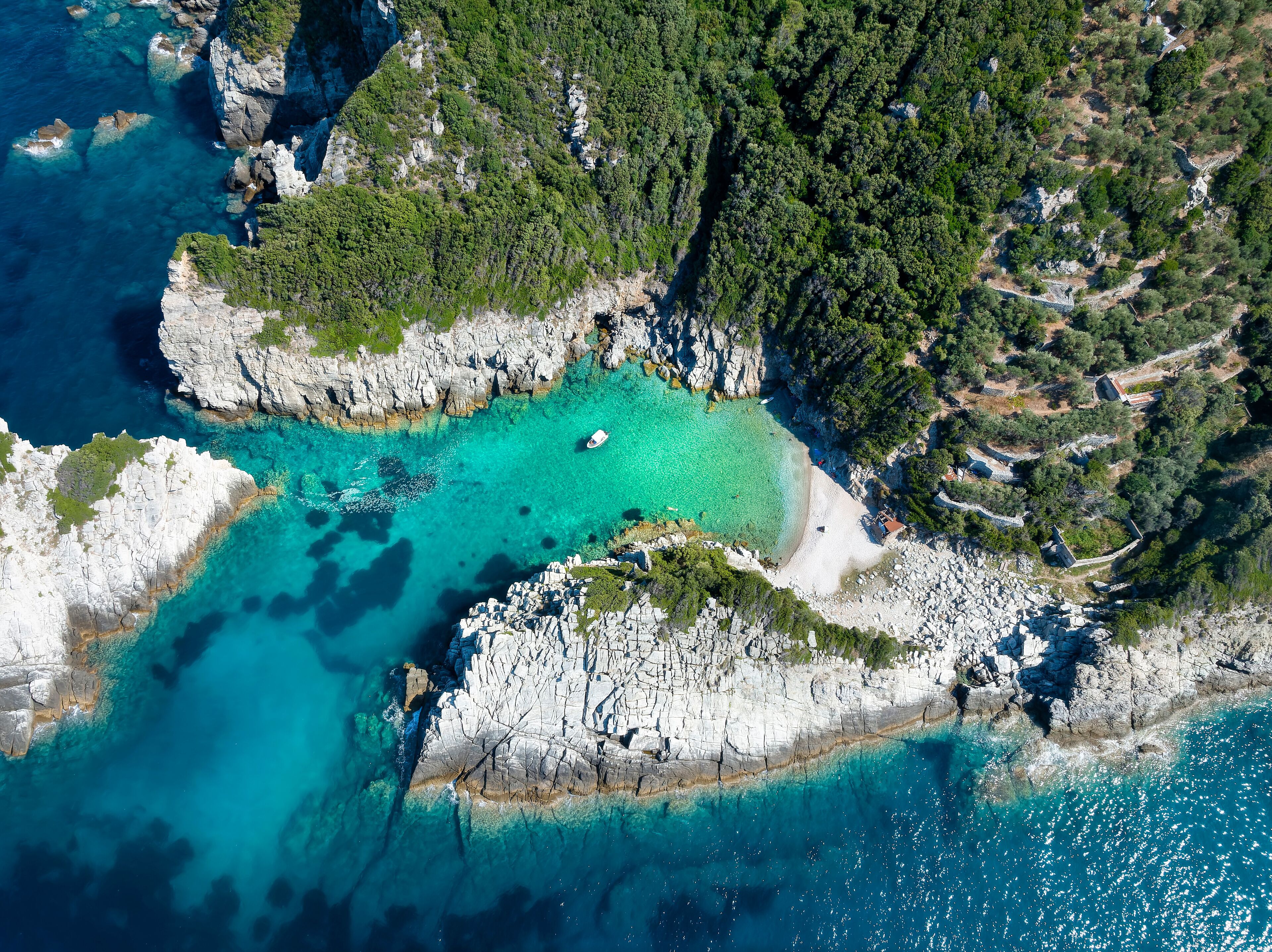 Aerial view of the secluded Spilia Beach at the rough and cliffy east coast of Skopelos island, Sporades, Greece
