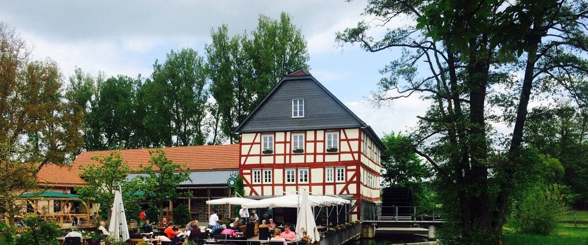 A traditional half-timbered building with a canal in front.