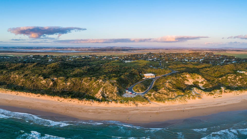 Venus Bay beach and surf club building at sunset - aerial panorama. Victoria, Australia