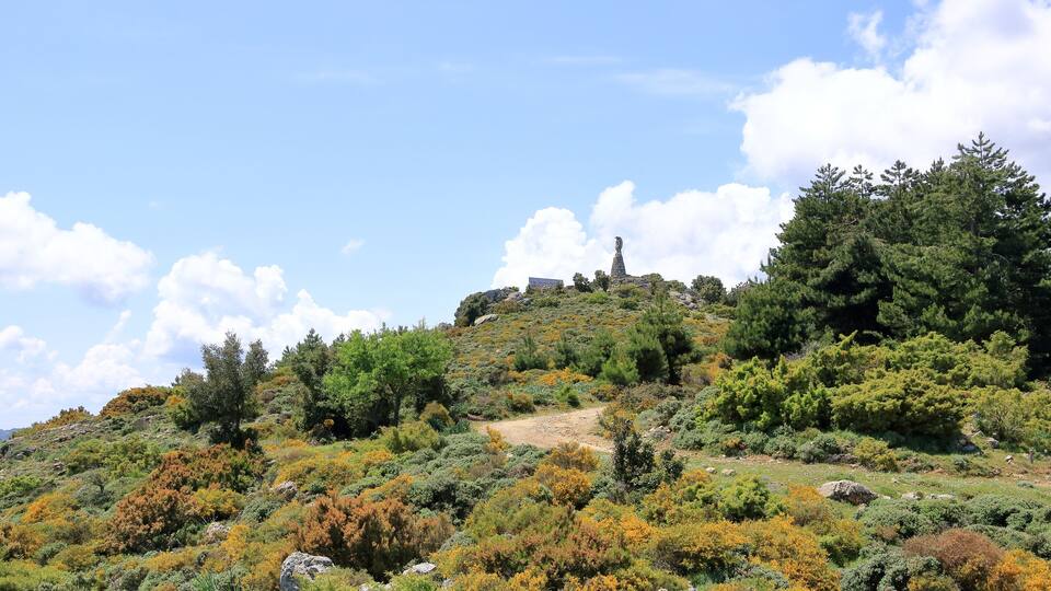 Statua San Michele on top of sardinian mountain landscape near Biddamanna Istrisàili/Villagrande Strisaili/Arzana, Italy