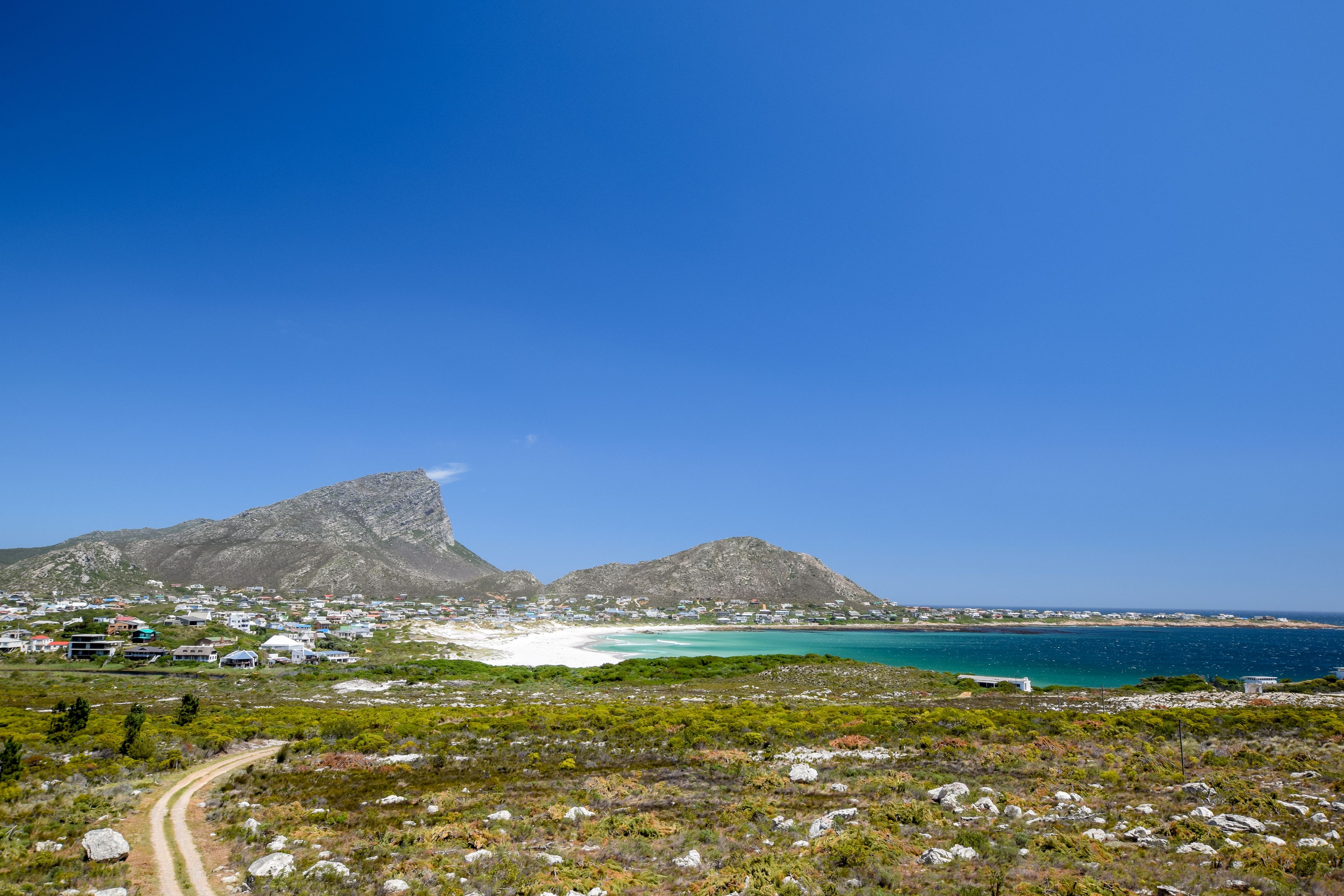 Beautiful view of Pringle Bay, a small beach village located along Route 44 in the eastern part of False Bay near Cape Town. Bushland in the foreground, Hangklip mountain in the background.
