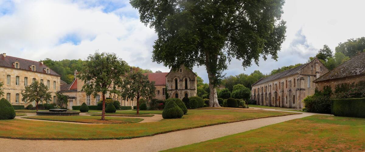 A historic estate with a large manor house, formal gardens, and a church.