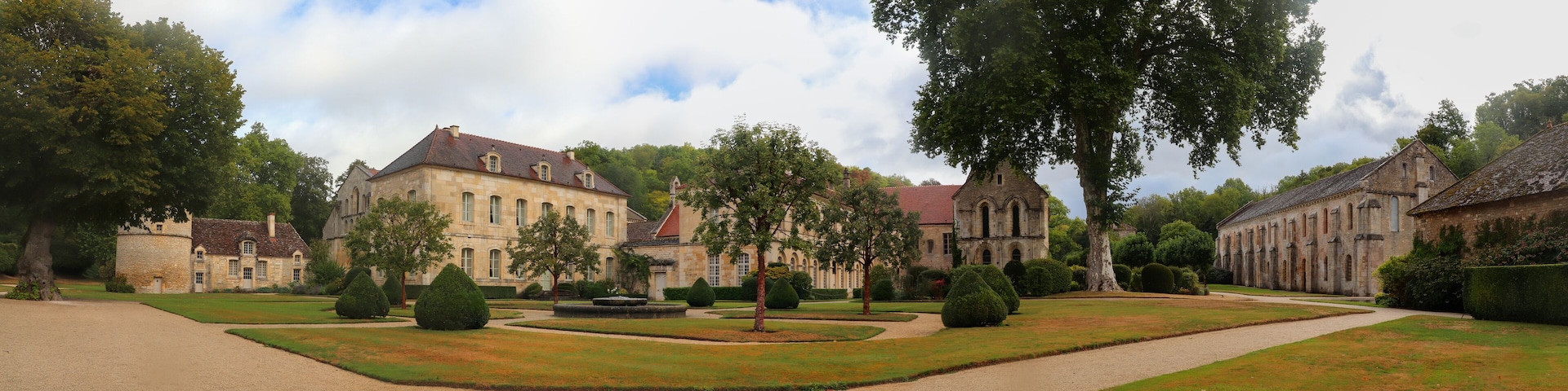 A historic estate with a large manor house, formal gardens, and a church.