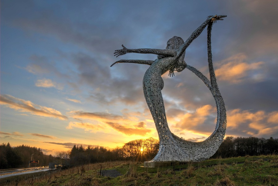 E46EJY Arria Sculpture by Andy Scott at sunrise