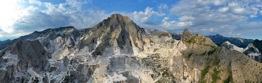 Aerial view of mountain of stone and marble quarries in the regional natural park of the Apuan Alps located in the Apennines in Tuscany, Massa Carrara Italy. Open pit mine