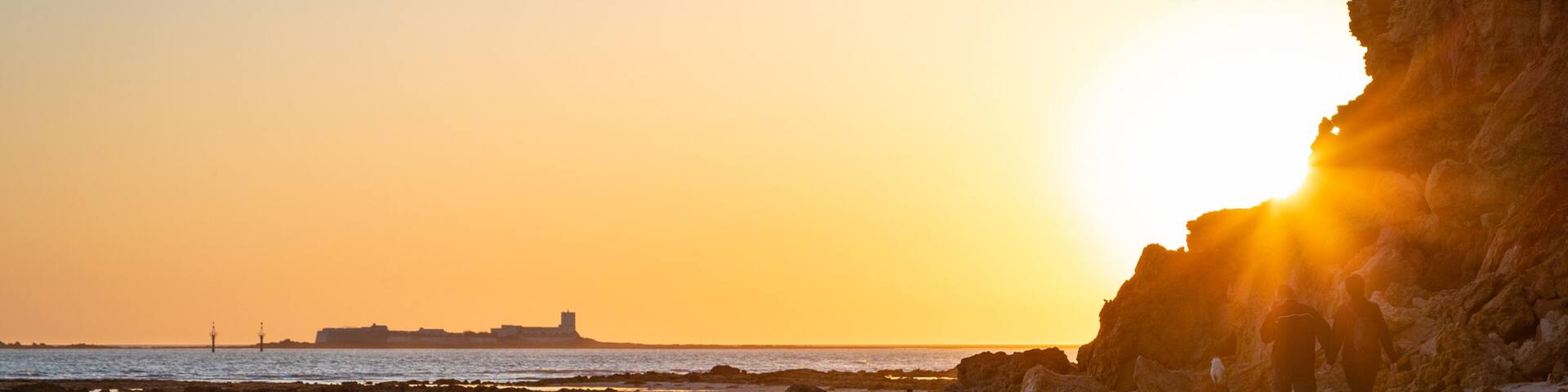 La Barrosa Beach featuring a sunset, general coastal views and a sandy beach