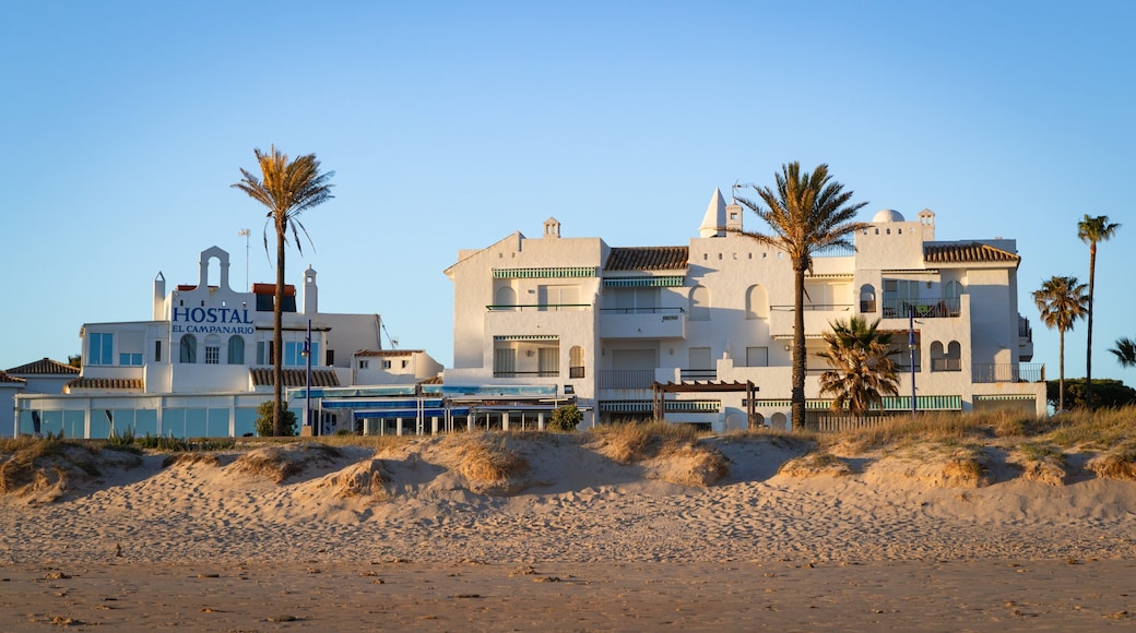 La Barrosa Beach featuring a coastal town, a sunset and a beach