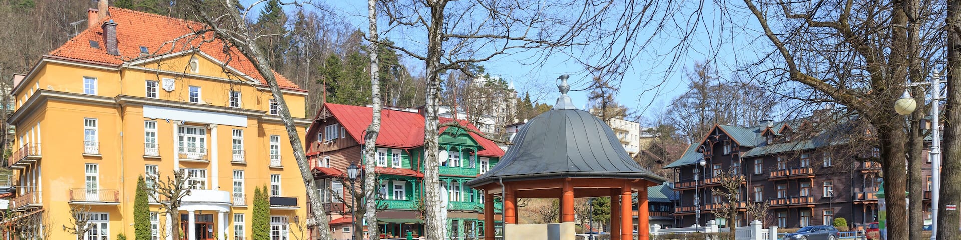 Krynica Zdroj. Spa promenade along Kryniczanka creek. On other side of creek rise historic buildings; Shutterstock ID 635574944