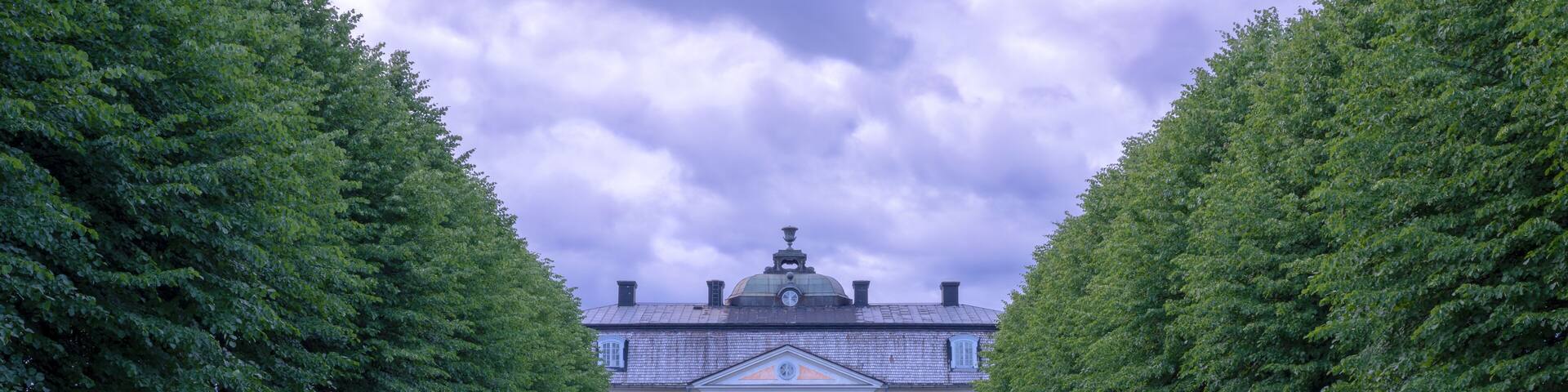 The old mansion in Osterbybruk, Sweden – view from the garden, a cloudy summer evening
