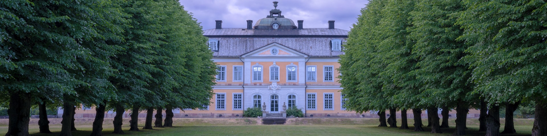 The old mansion in Osterbybruk, Sweden – view from the garden, a cloudy summer evening