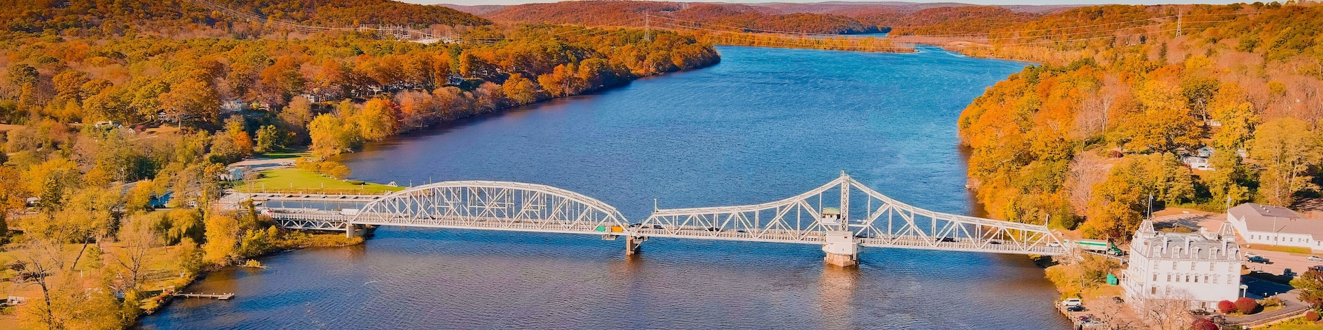 Autumn forest on the riverside, beautiful trees, blue river and bridge. Fall colors. View above. East haddam, Connecticut