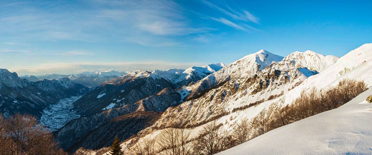A snow-covered mountain range with rugged peaks and valleys.