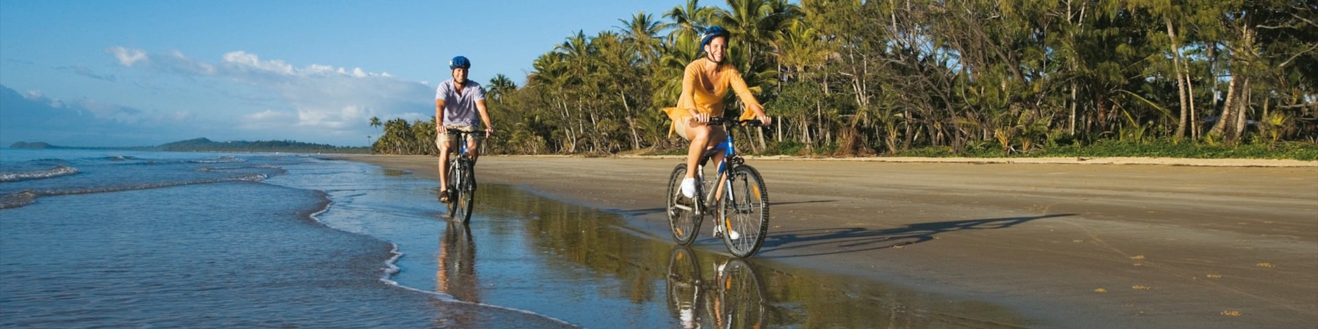 Mission Beach featuring mountain biking and a sandy beach as well as a small group of people