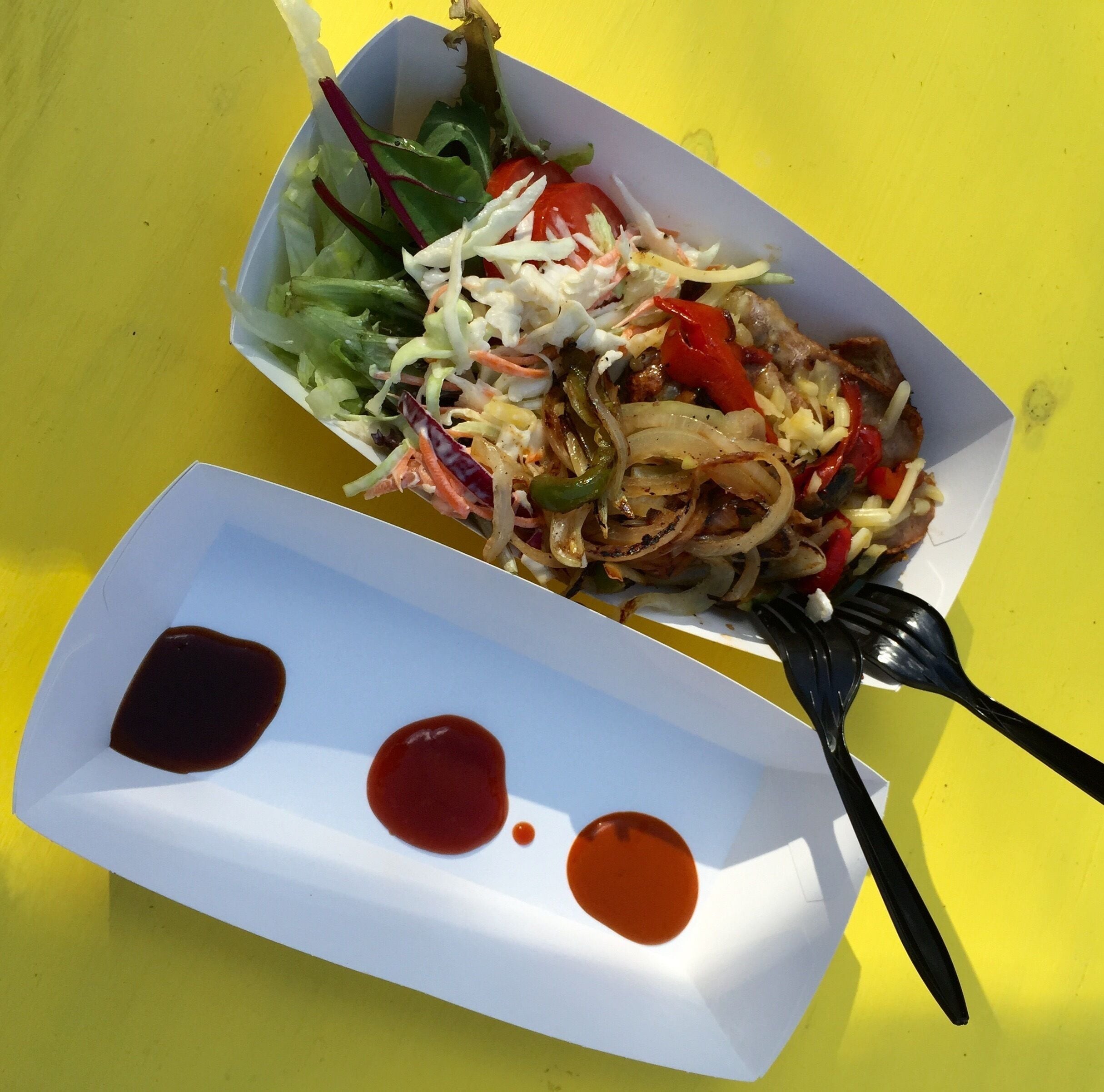 Tasty sausage with salad at the cheerful square