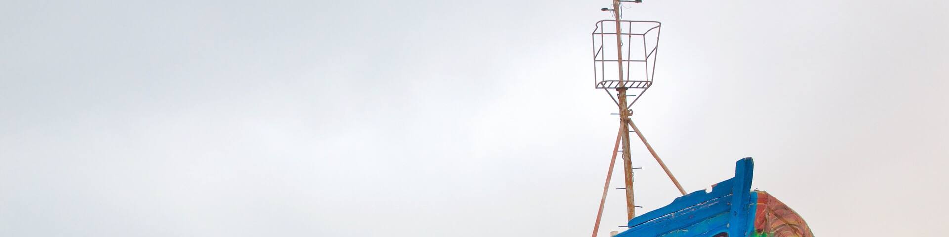 Caldera featuring outdoor art and a sandy beach