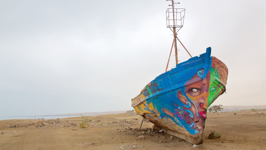 Caldera showing outdoor art and a beach