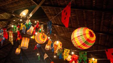 Traditional flags and lanterns of June festivities in northeastern Brazil. Background colorful.