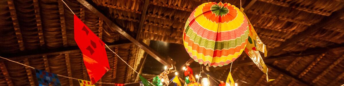 Traditional flags and lanterns of June festivities in northeastern Brazil. Background colorful.