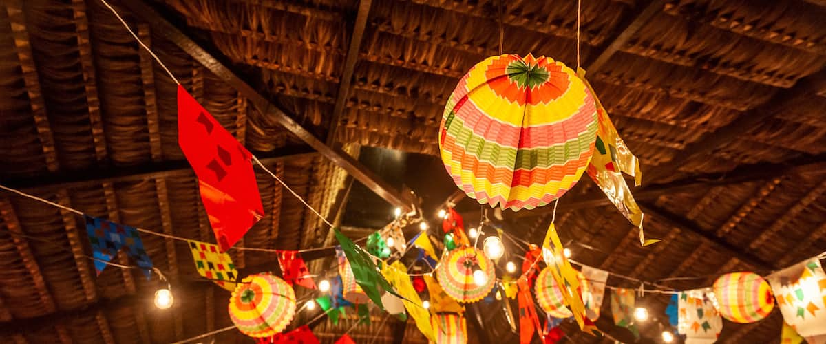 Traditional flags and lanterns of June festivities in northeastern Brazil. Background colorful.