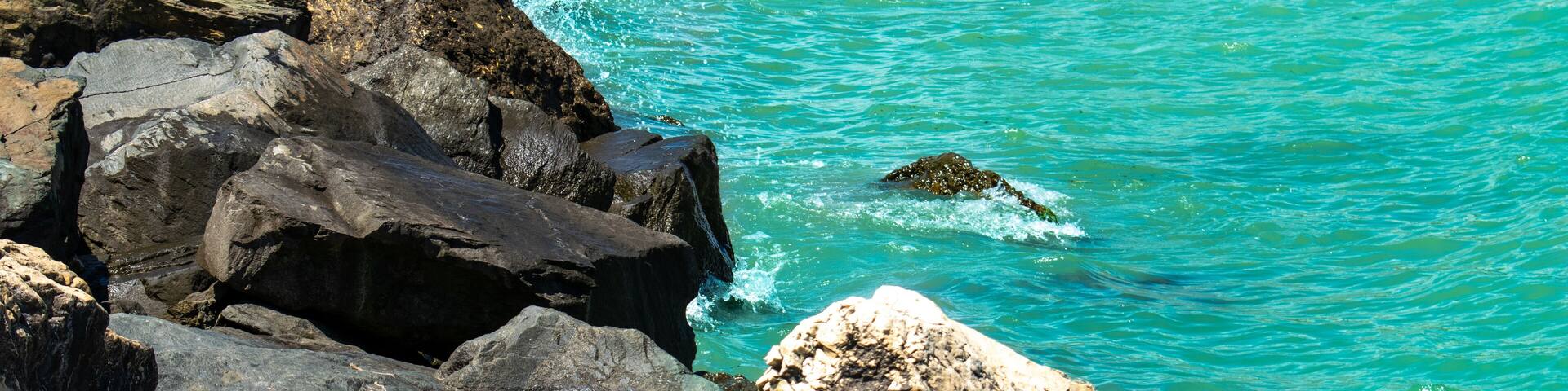 Waves hitting rocks at the Black Sea, Romania, colorful blue sea