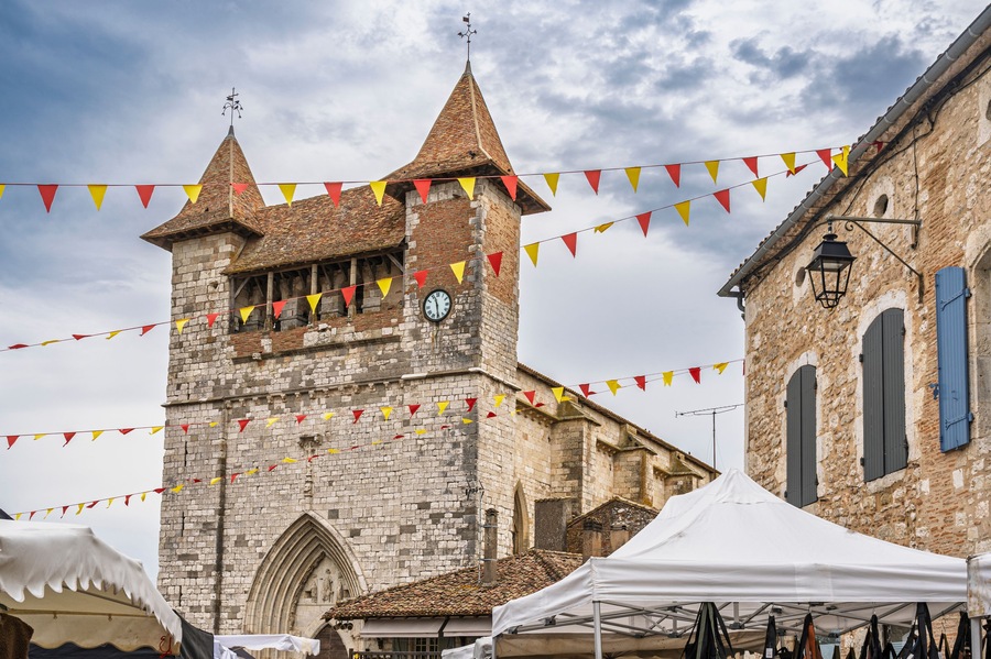 Landscape view of the facade of ancient Notre Dame church in medieval Villereal town, Lot-et-Garonne, France