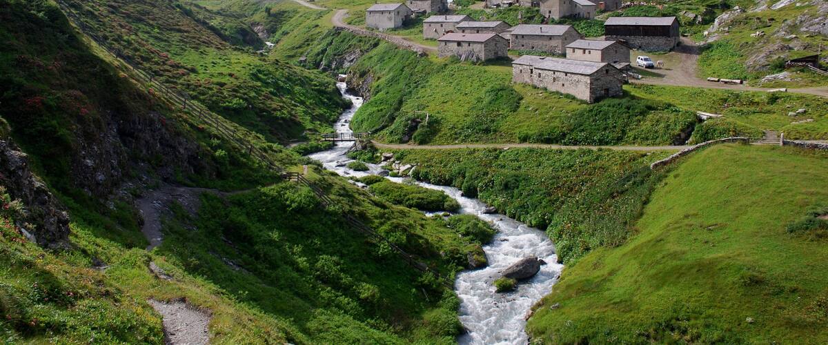 A mountainous village with a river flowing through it.