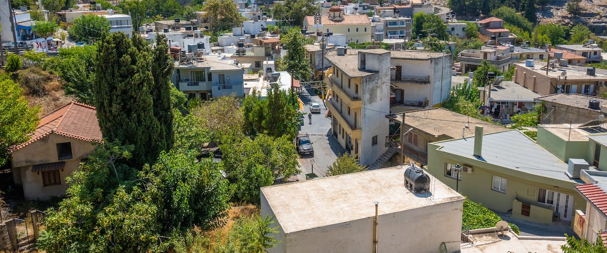 A hilly town with buildings and greenery.