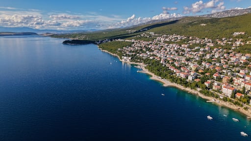 Aerial drone view of Crikvenica and Dramalj with turquoise Adriatic Sea, green-blue waters, beaches, and the island of Krk in the distance. Taken on 27.09.2025 in Dramalj, Croatia.