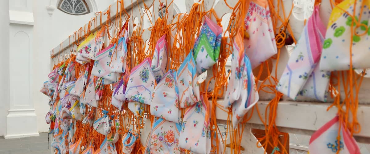 A wall adorned with colorful bags hanging in a row.
