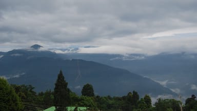 Kalimpong is a small hill town nestled in the Himalayas. Its less touristy thus calm and offers long walks, treks, meditation spots, exploring local market, nice places to eat and drink and above all happy people.
This picture is taken from the top floor room of Alaknanda Resort run by a friendly Mrs Subba. A nice place to stay.