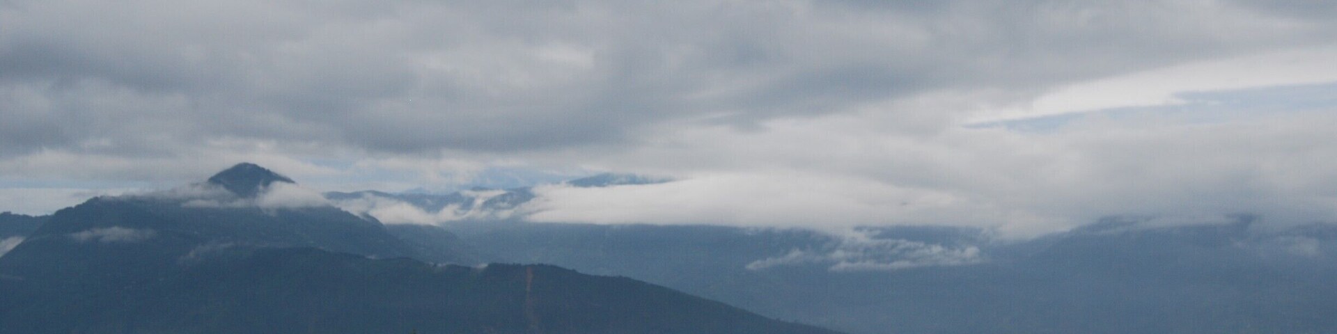 Kalimpong is a small hill town nestled in the Himalayas. Its less touristy thus calm and offers long walks, treks, meditation spots, exploring local market, nice places to eat and drink and above all happy people.
This picture is taken from the top floor room of Alaknanda Resort run by a friendly Mrs Subba. A nice place to stay.