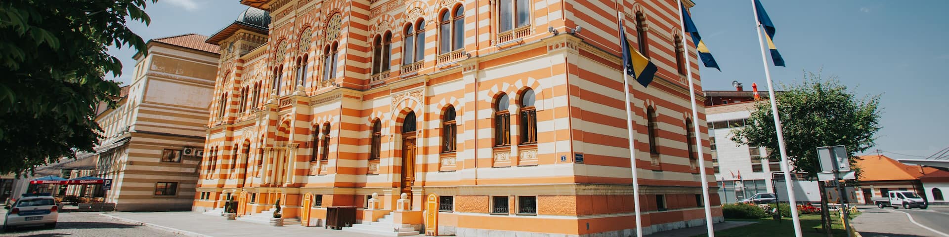 A historic building with striped architecture and a clock tower.