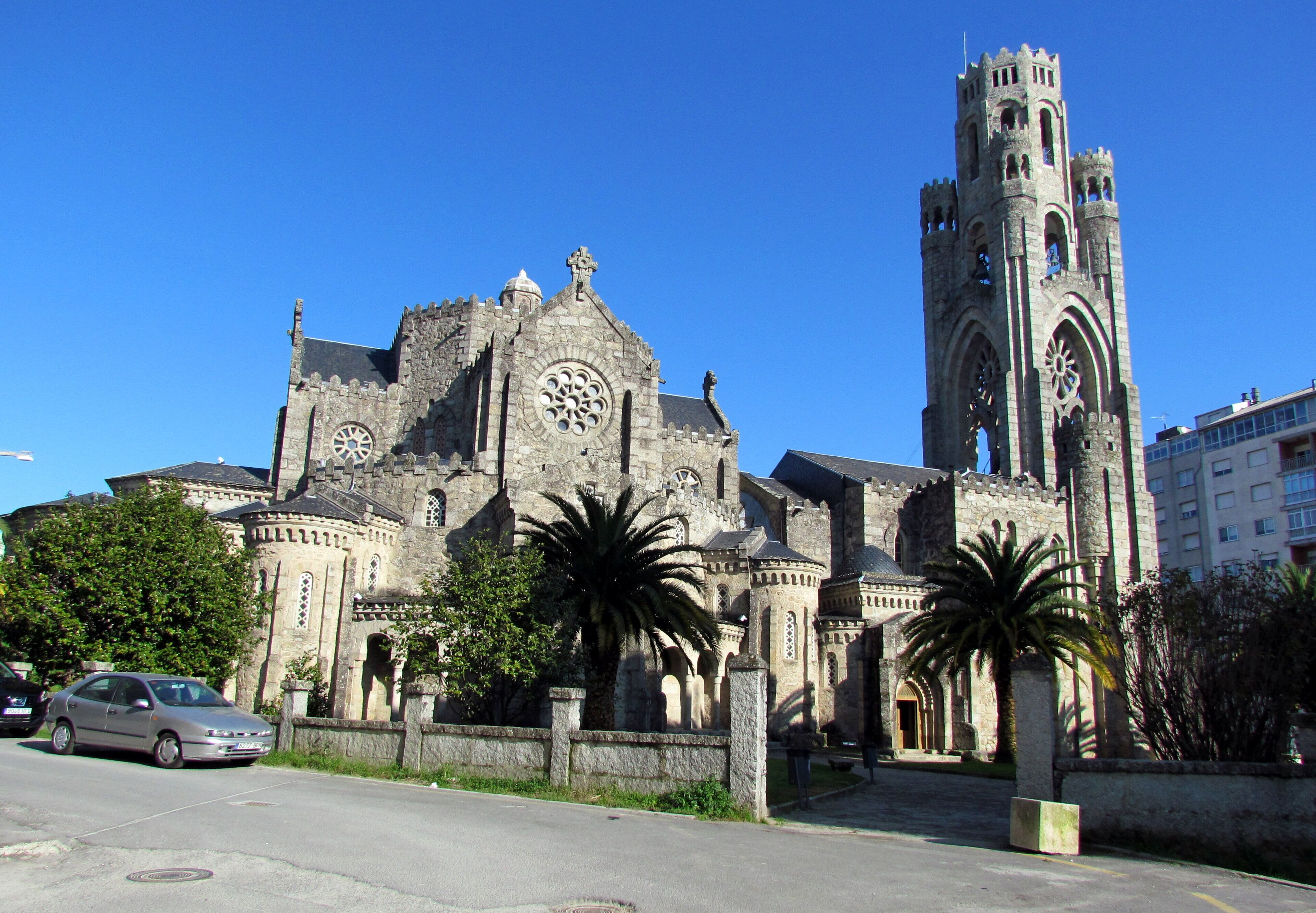 A historic church with a tall tower and large clock.