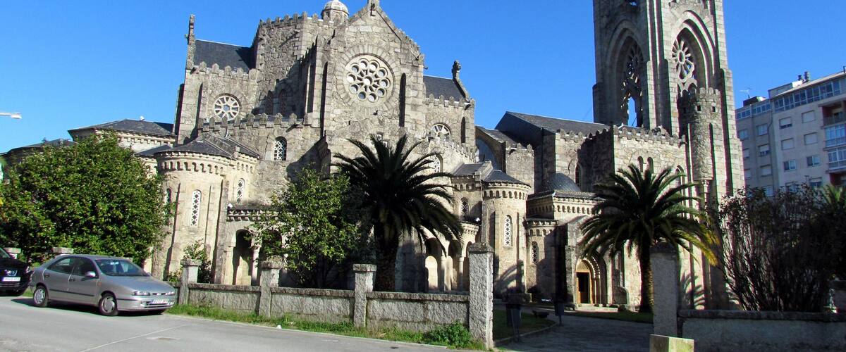 A historic church with a tall tower and large clock.