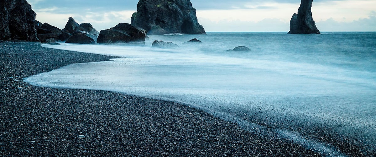 Basalt sea stacks called the Reynisdrangar protrude from the North Atlantic. Legend has it that three trolls were pulling a masted ship to shore and were caught in the early morning sunlight, which froze them into needles of rock.
#blue