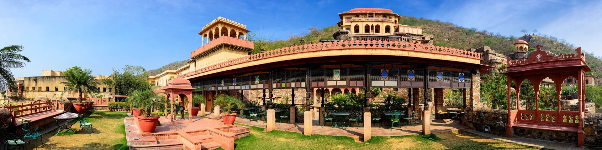 A traditional building with a curved roof and a tower.