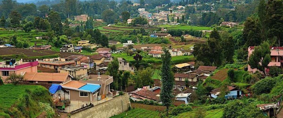 A rural village with terraced fields, houses, and a prominent church.