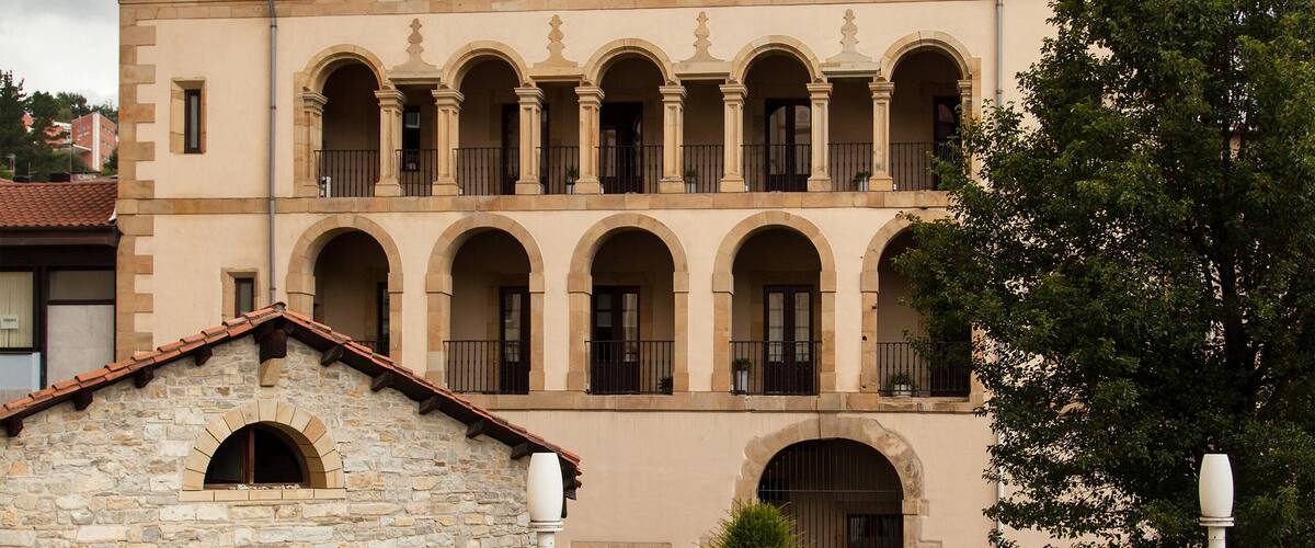 A historic building with two domes and a courtyard.