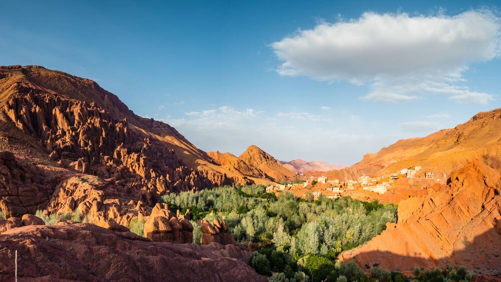 A rugged mountainous landscape with a village nestled in the valley.
