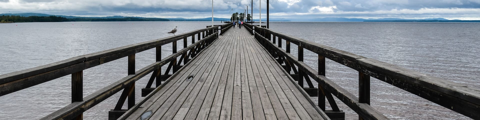 Long wooden pedestrian pier jutting out in Siljan Lake - Rattvik, Sweden.