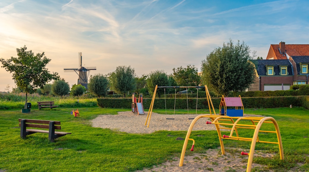Child-friendly dutch neighborhood with playground and a traditional windmill in the village of Terheijden, North Brabant, The Netherlands