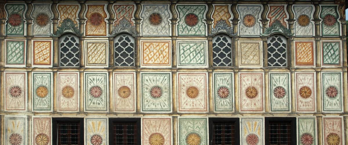 A wall with intricate tile patterns and decorative elements.