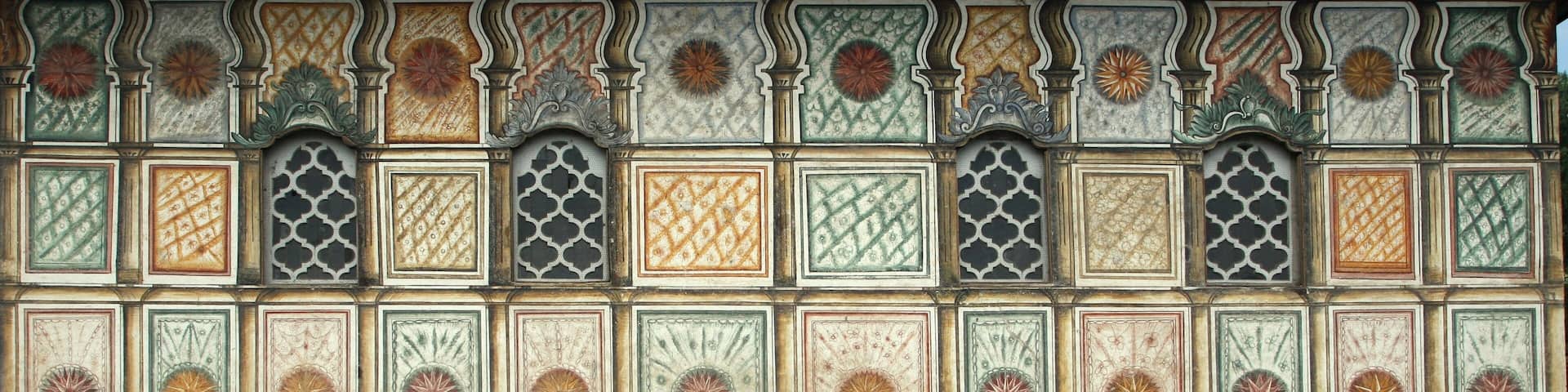 A wall with intricate tile patterns and decorative elements.