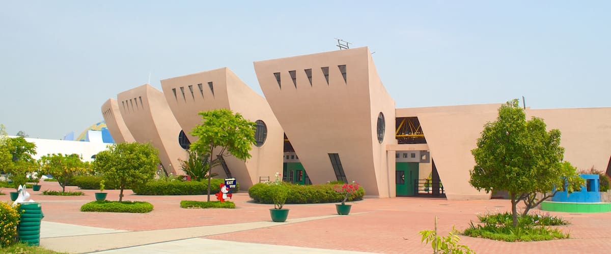 A modern building with unique angular architecture and a clear blue sky.