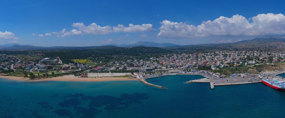 Aerial drone bird's eye panoramic view of famous port and city of Rafina with passenger ferries travel to Aegean islands, Attica, Greece