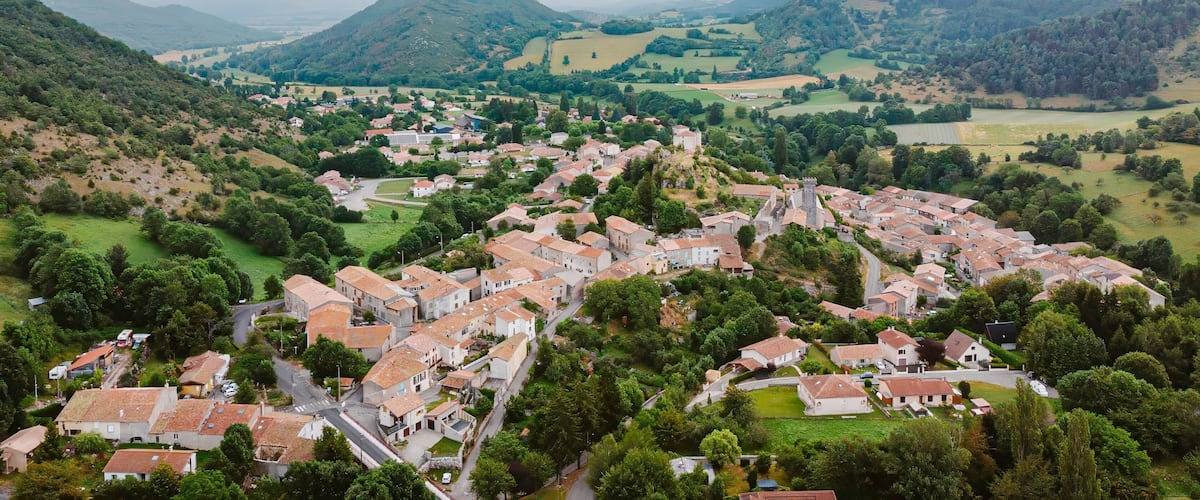 A village nestled in a valley surrounded by hills.